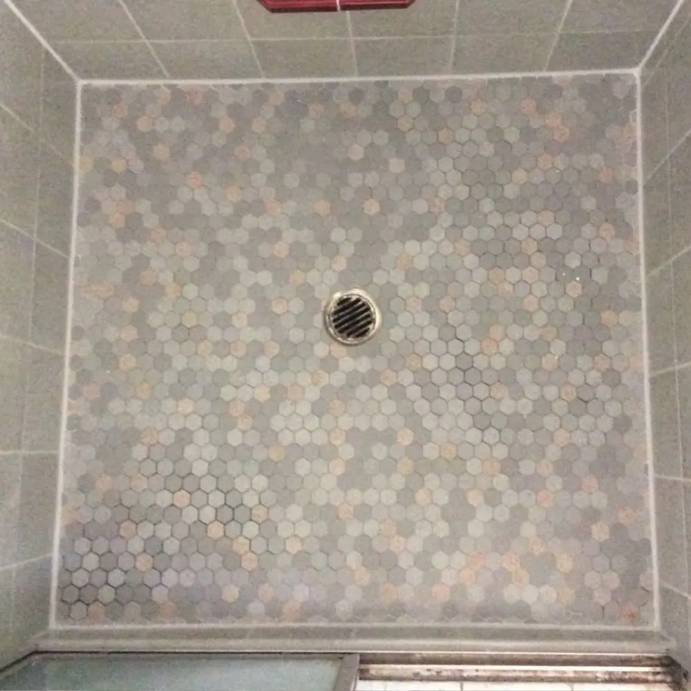 Regrouted hexagon mosaic shower