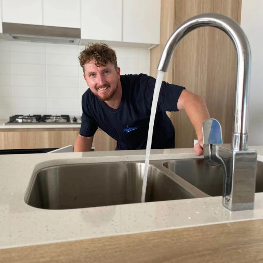 Bryce testing a kitchen mixer tap after a service